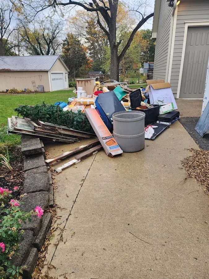 Dumpster being loaded with debris for Estate Cleanout Dumpster Rental in Laurel Hill